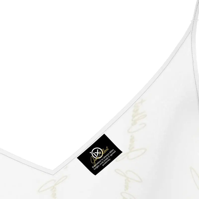 White satin slip dress neckline close-up with brand tag and gold embroidery