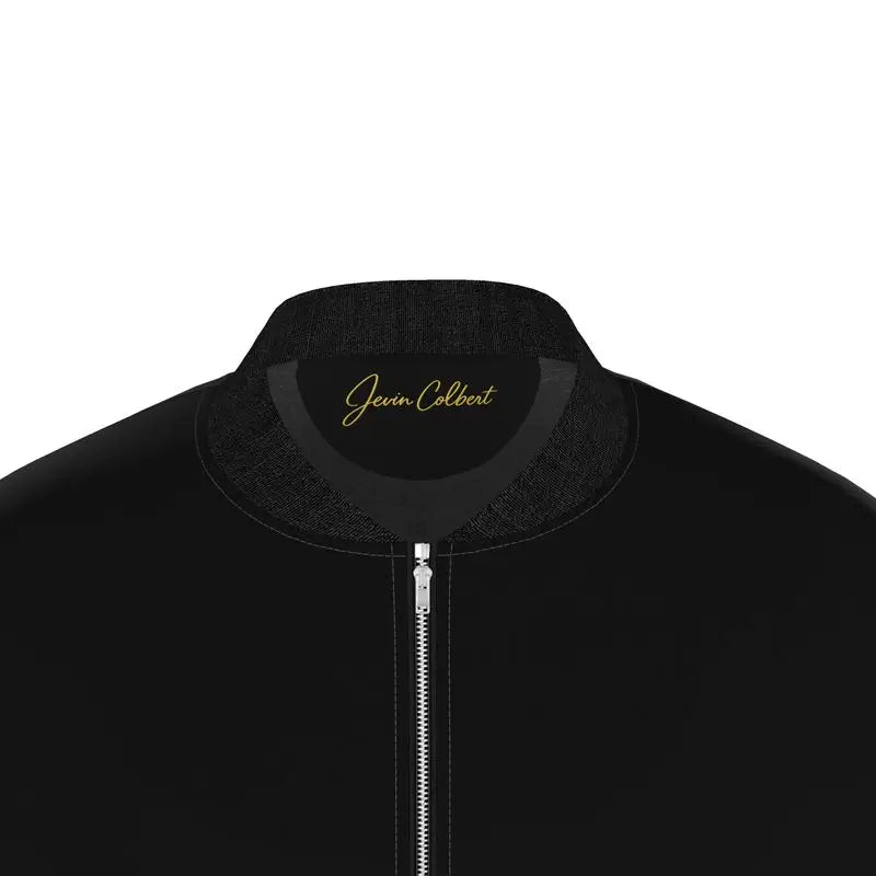 Men's black bomber jacket collar close-up with gold logo and front zipper