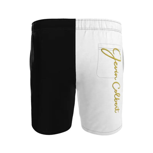 Two-tone men's swim shorts with black left, white right, gold script, zip pocket