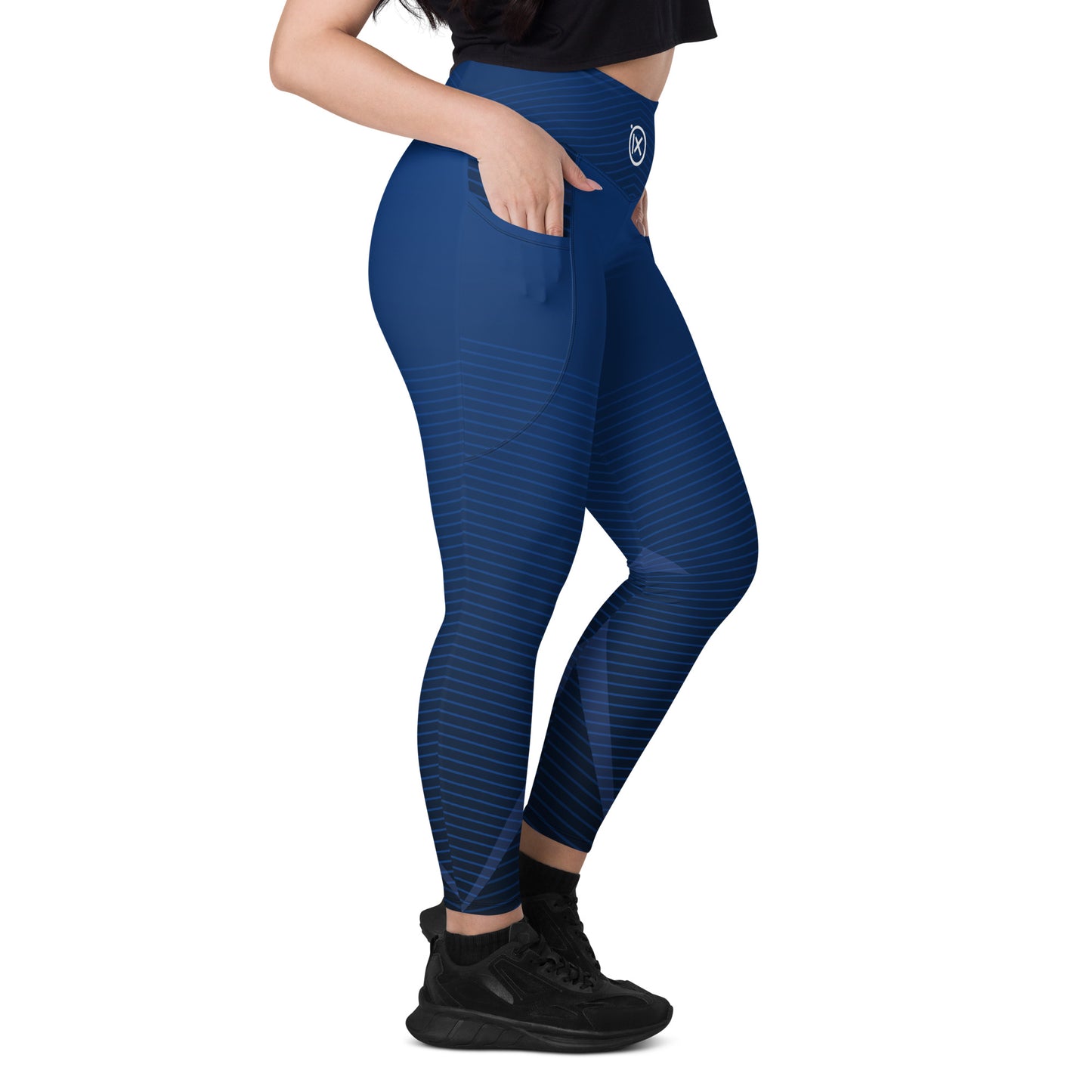 Blue performance leggings close-up: side pocket and geometric stripe pattern at thigh