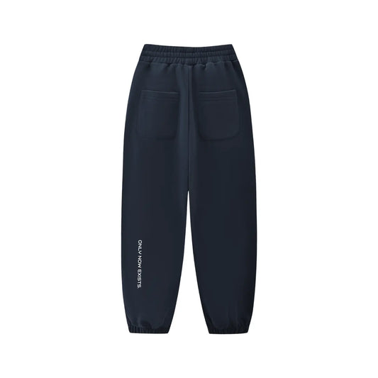 Kids fleece jogger in dark navy, elastic waistband and cuffs, back view with pocket logo