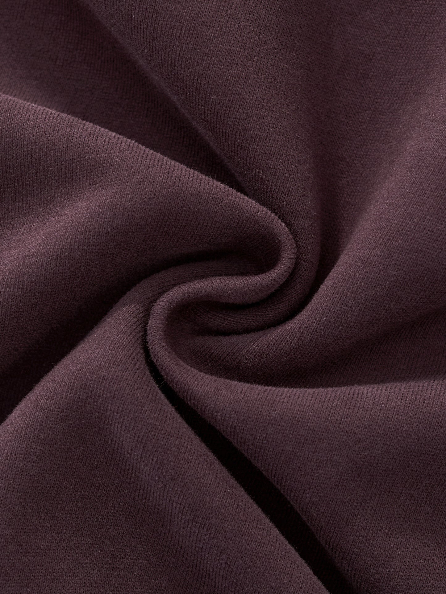 Women’s hoodie fabric detail in dark reddish purple with smooth seam fold