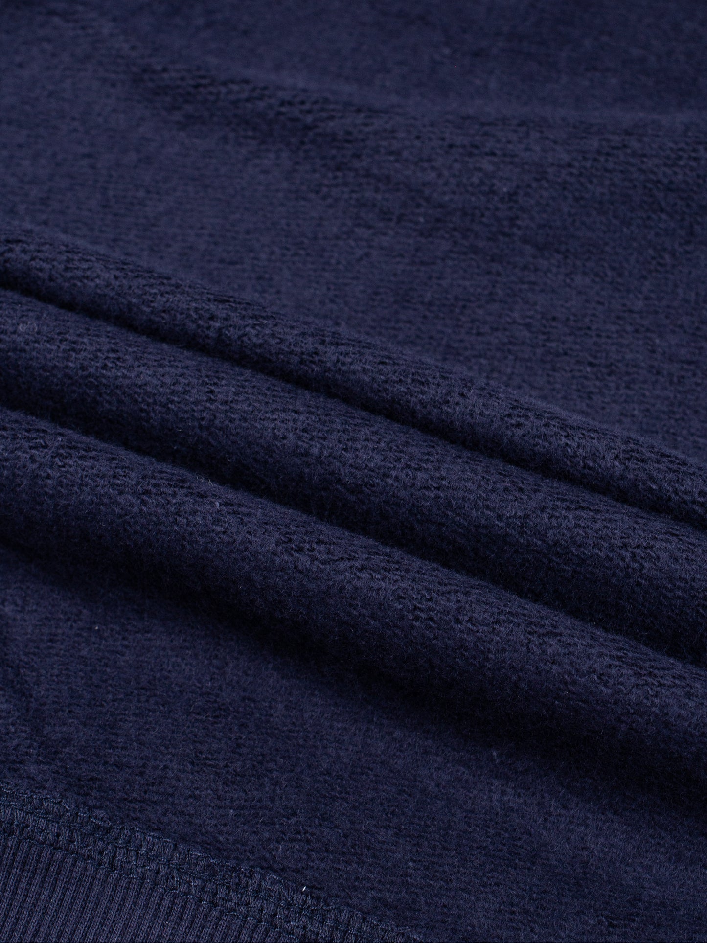 Kids fleece crewneck, navy fleece with seam and knit texture close-up