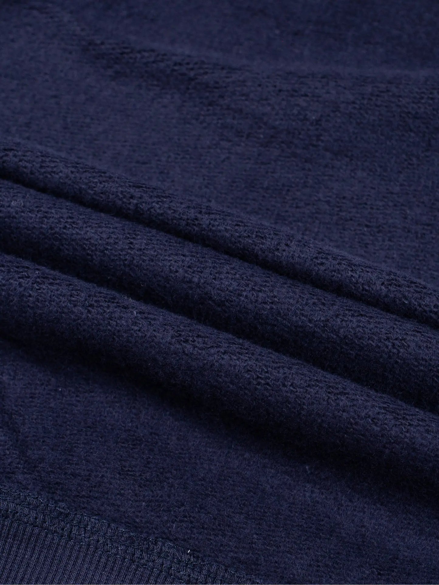 Kids fleece crewneck, navy fleece with seam and knit texture close-up