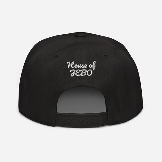Black snapback cap with small white logo text on the back panel and adjustable strap