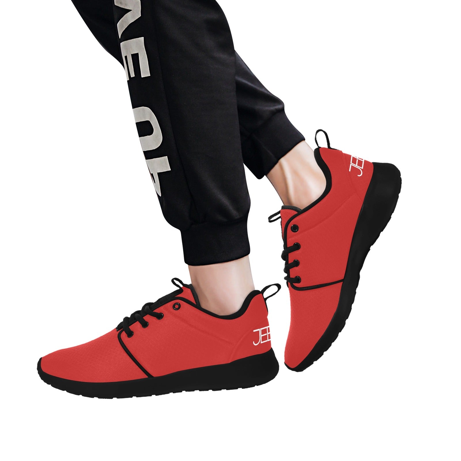 Red lace-up running shoes worn with black jogger pants