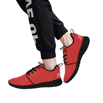 Red lace-up running shoes worn with black jogger pants