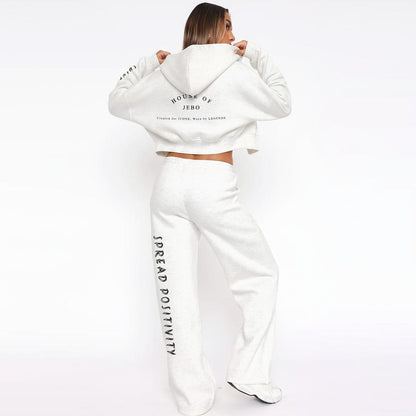 Women’s white fleece tracksuit set with zip hoodie and wide-leg sweatpants, back graphic.