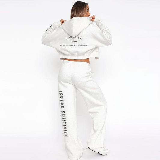 Women’s white fleece tracksuit set with zip hoodie and wide-leg sweatpants, back graphic.