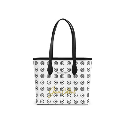 White leather tote with black top handles and repeating monogram pattern, front logo