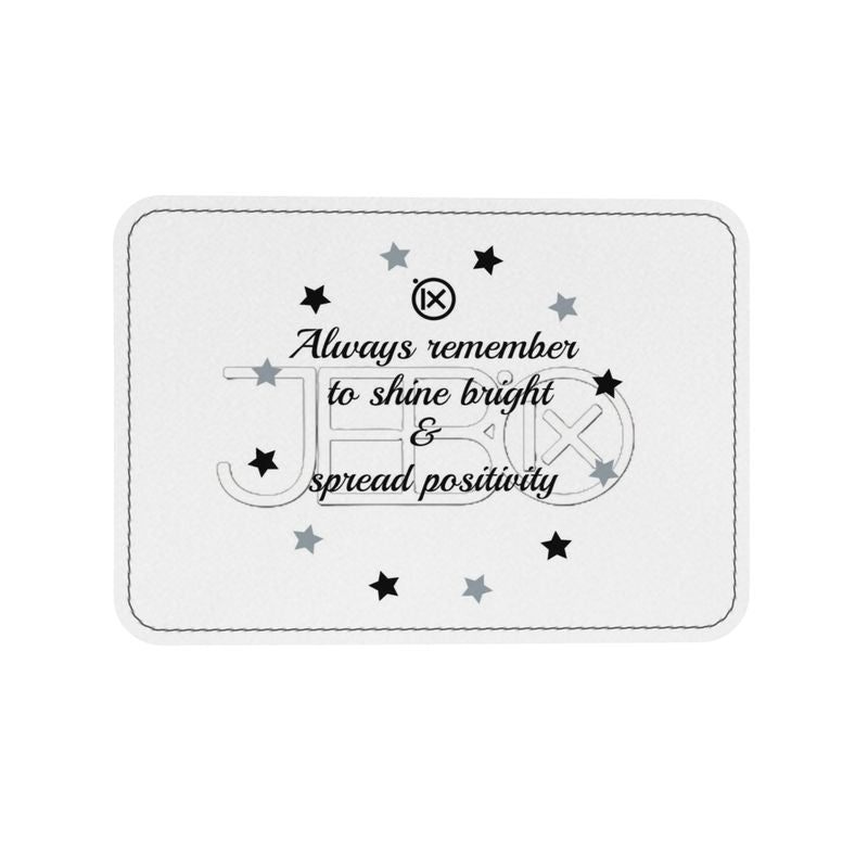 White leather label with stitched edge, star icons and uplifting quote