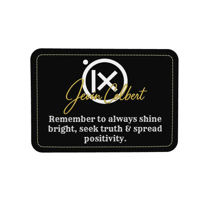 Black rectangular logo patch with gold script and motivational slogan text.