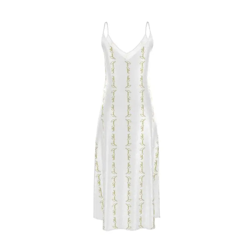 White slip dress with V-neckline, thin straps, and gold script embroidery detail