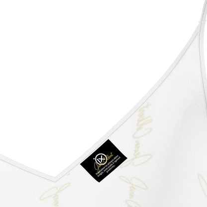White satin slip dress neckline close-up with brand tag and gold embroidery