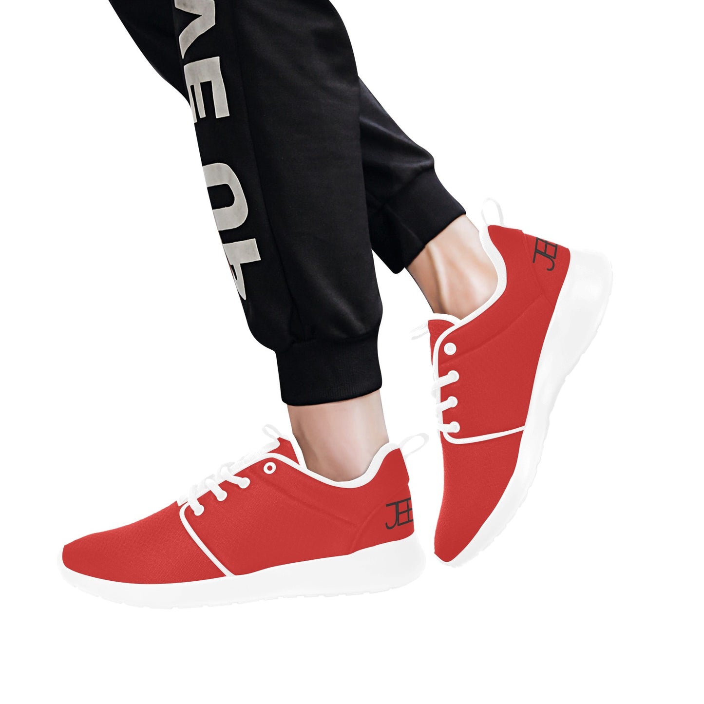 Red mens runner sneakers with white trim, worn with black pants