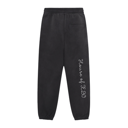 Black joggers with side logo text, back patch pocket, and elastic ankle cuffs