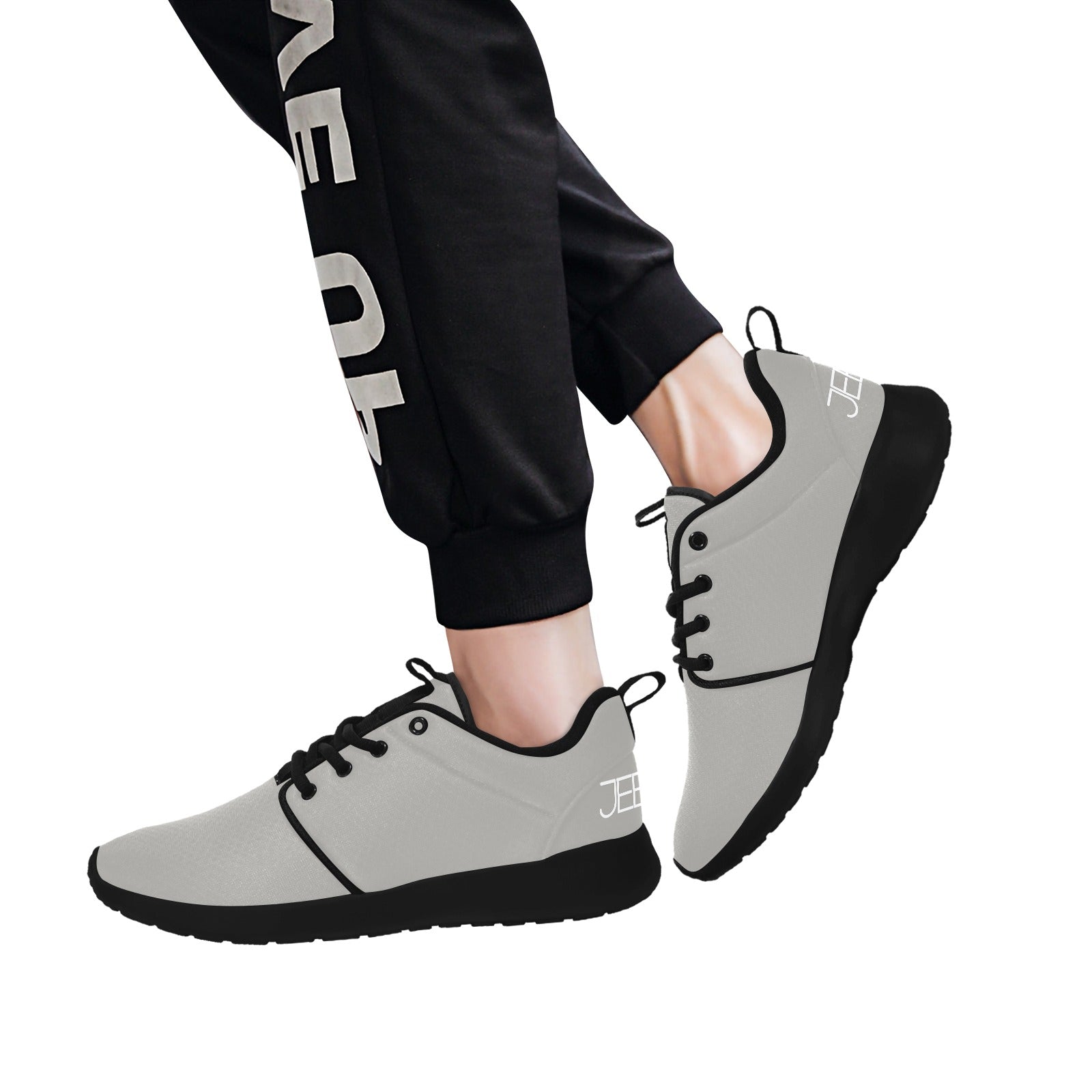 Men's core runner sneakers worn with black pants; light gray upper and black outsole