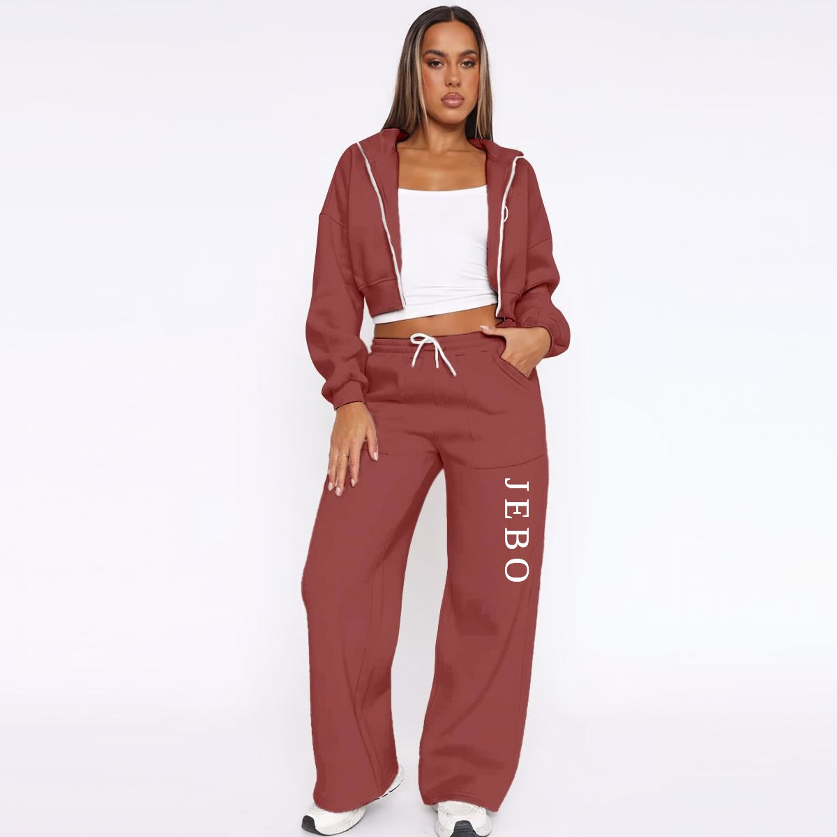 Maroon fleece tracksuit: zip hoodie and drawstring wide-leg joggers with vertical logo text.