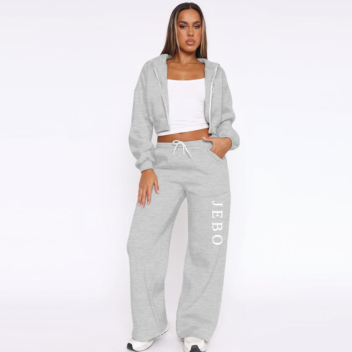 Gray fleece tracksuit: zip hoodie over white top and drawstring wide-leg joggers with logo.
