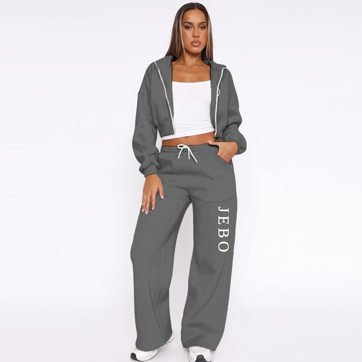 Dark gray fleece tracksuit: zip hoodie and drawstring wide-leg joggers with vertical logo text.
