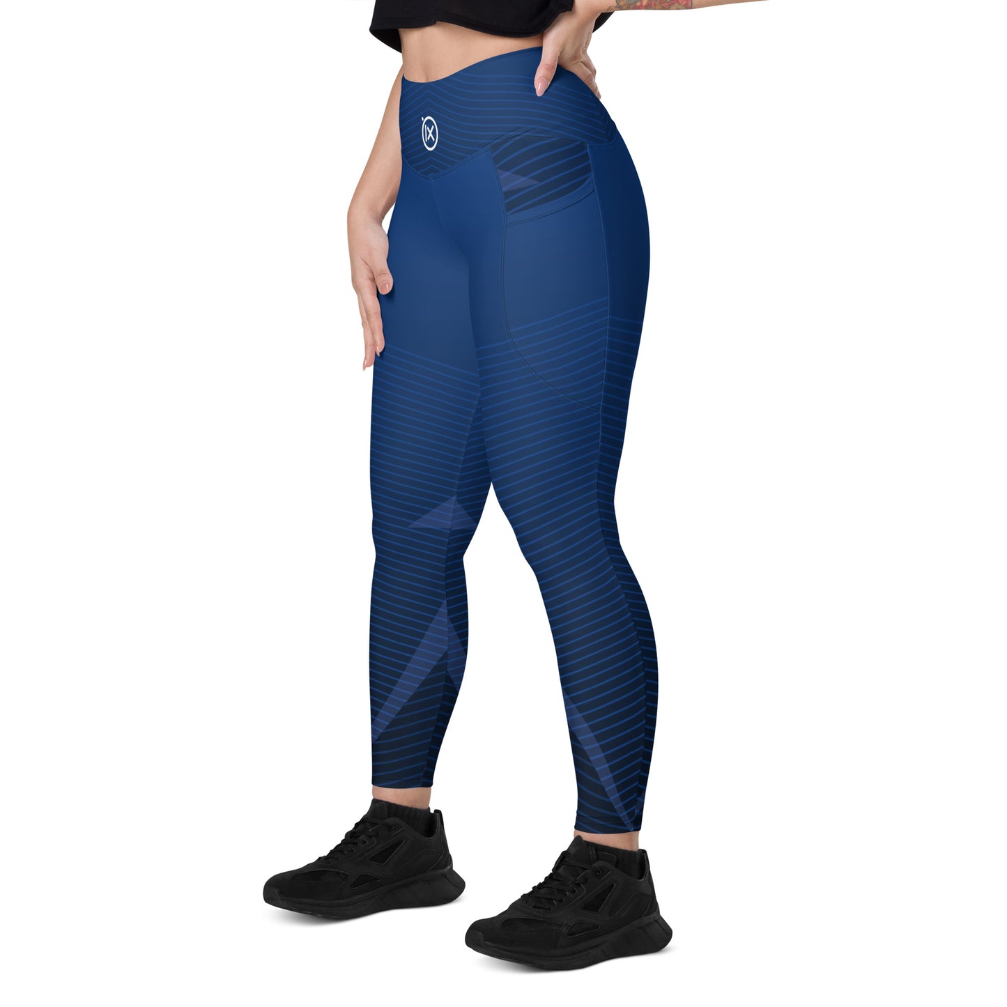 Blue performance leggings with diagonal stripe pattern and small back logo badge, ankle length.