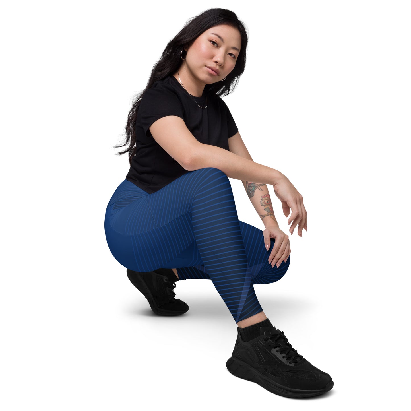 Dark blue performance leggings with striped wave pattern and mid-calf length