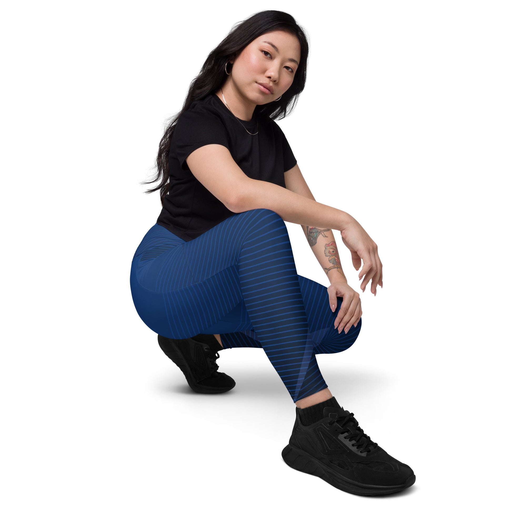 Dark blue performance leggings with striped wave pattern and mid-calf length