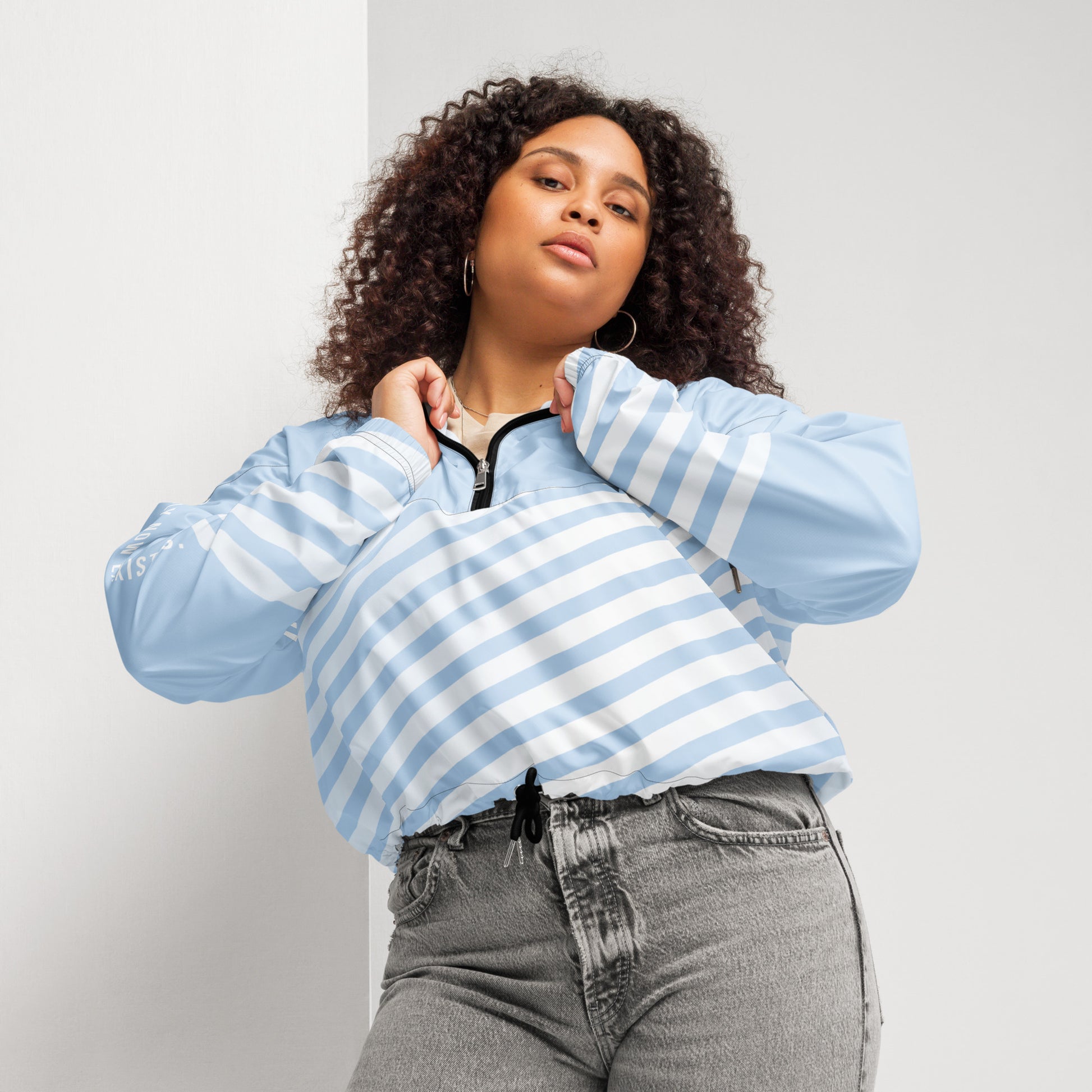 Light blue windbreaker with striped front, hood, and center zip closure