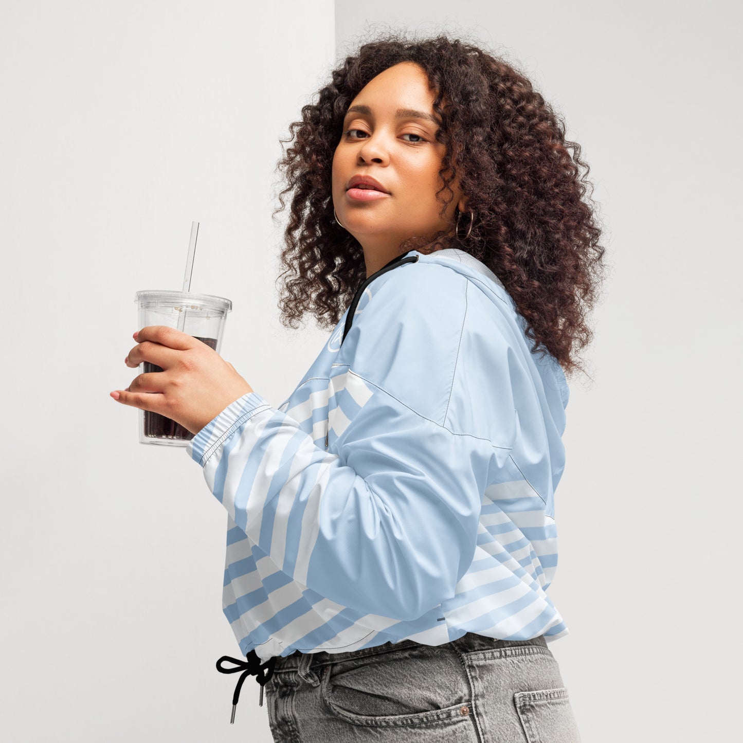 Cropped windbreaker in light blue with white stripes, hooded design and drawstring hem
