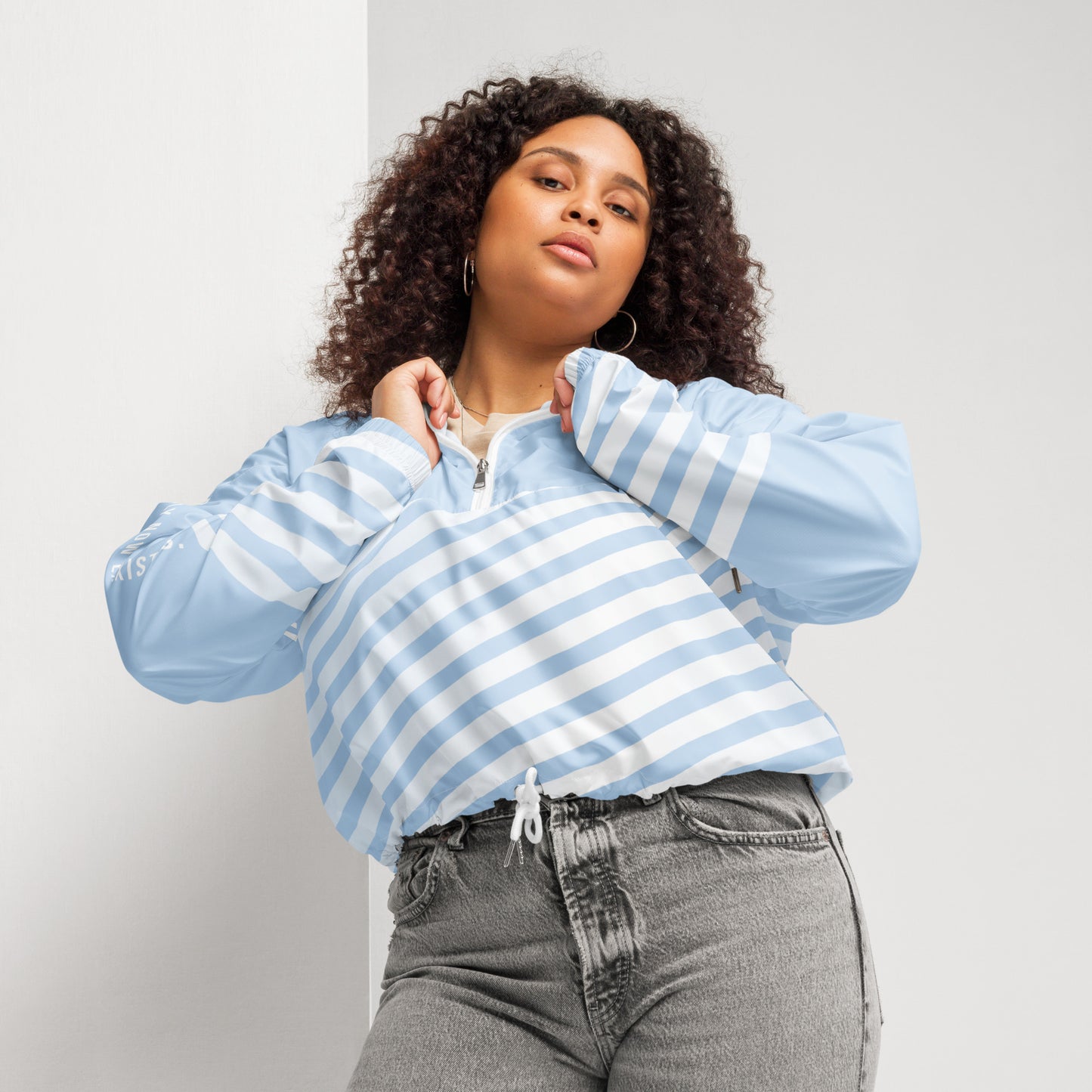 Cropped windbreaker in light blue with white stripes, quarter-zip and hood