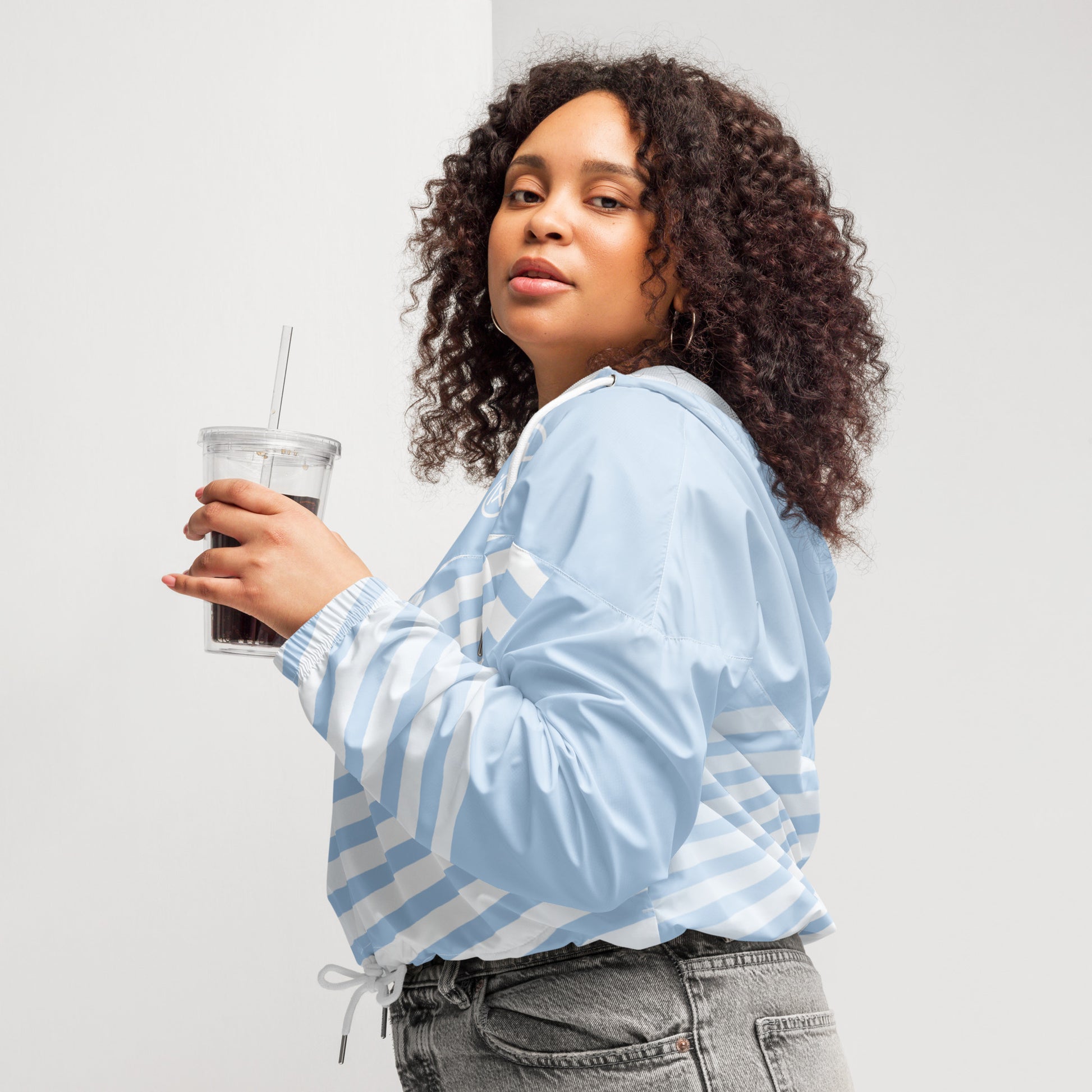 Cropped windbreaker in light blue with white stripes, zip front and drawstring hem