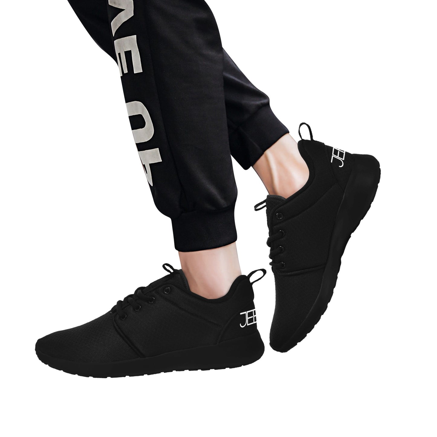 Mens core runner shoes on model, black lace-up sneakers with JEBIX logo on side