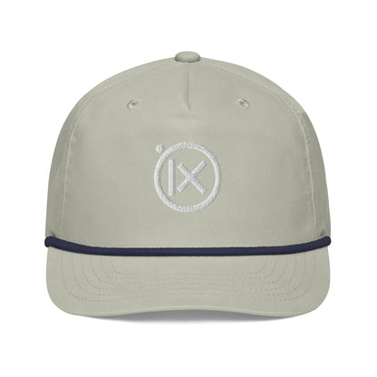 Light gray baseball cap with navy trim and white circular X logo on front.