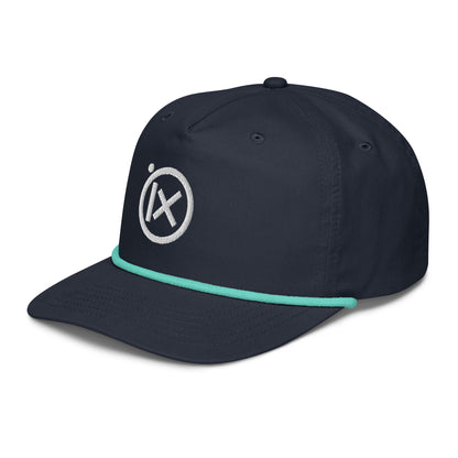 Navy golf snapback cap with turquoise rope trim and circular X logo on side.