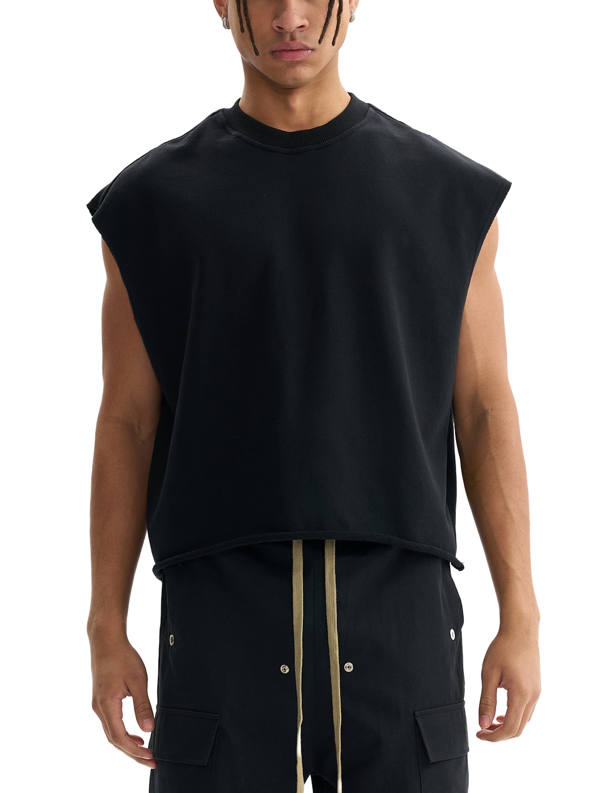 Black boxy tank top on model, sleeveless crew neck, relaxed fit
