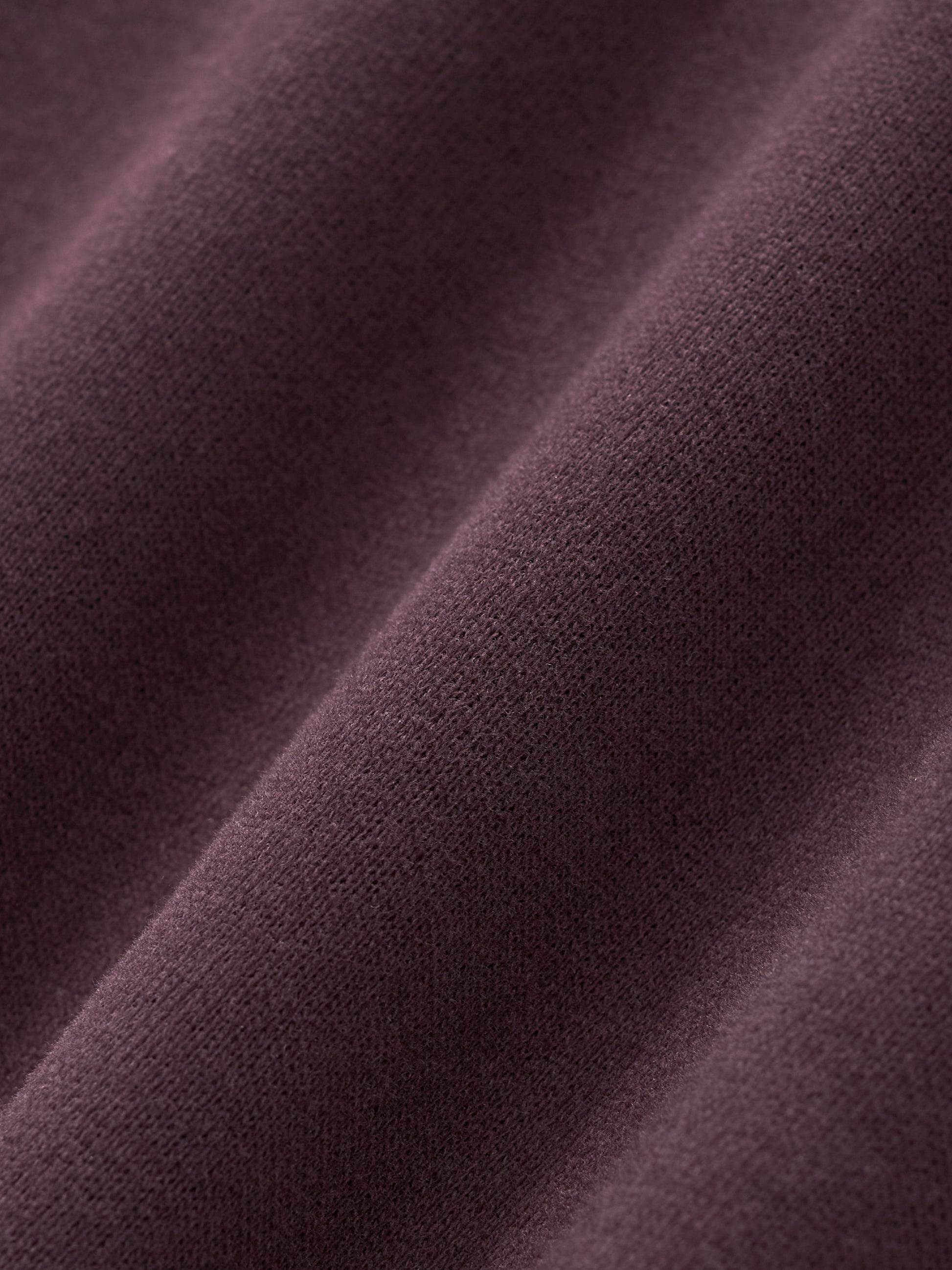 Women’s cropped hoodie fabric in dark reddish purple with fine knit texture