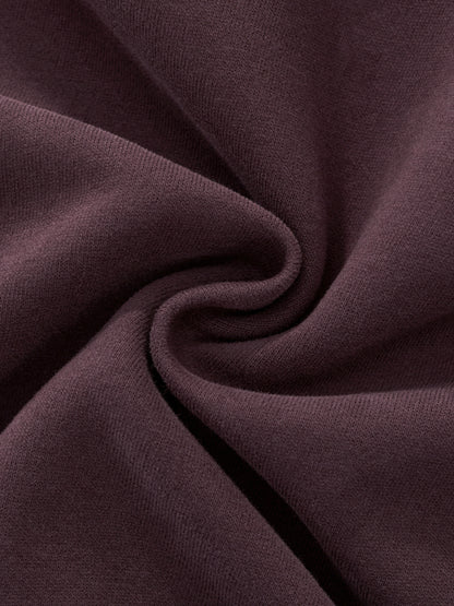 Women’s hoodie fabric detail in dark reddish purple with smooth seam fold