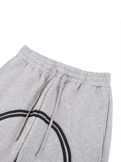 Heather gray joggers close-up: elastic waistband and drawstring with black side stripe