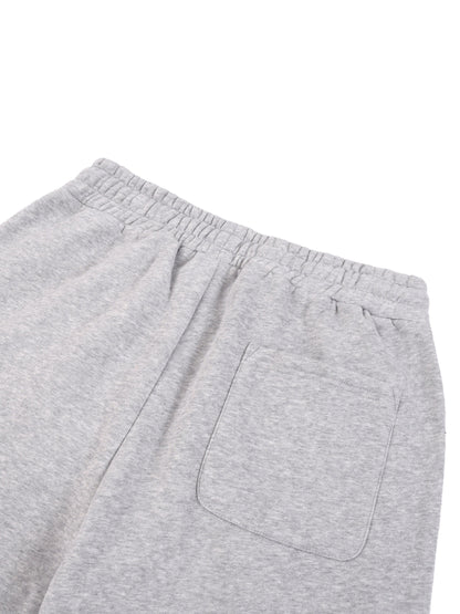 Heather gray joggers close-up: back patch pocket and relaxed leg drape