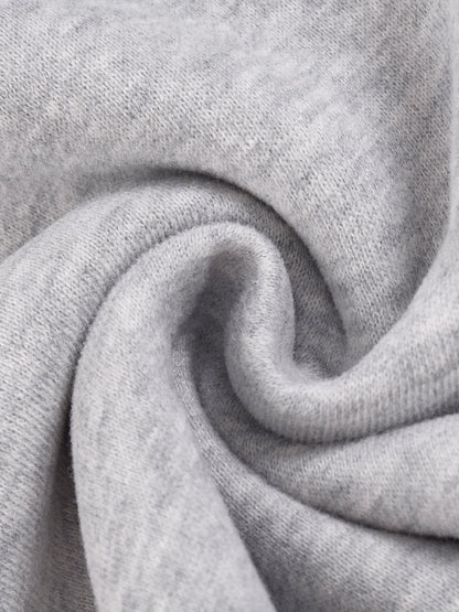 Heather gray knit fabric close-up with folded texture detail