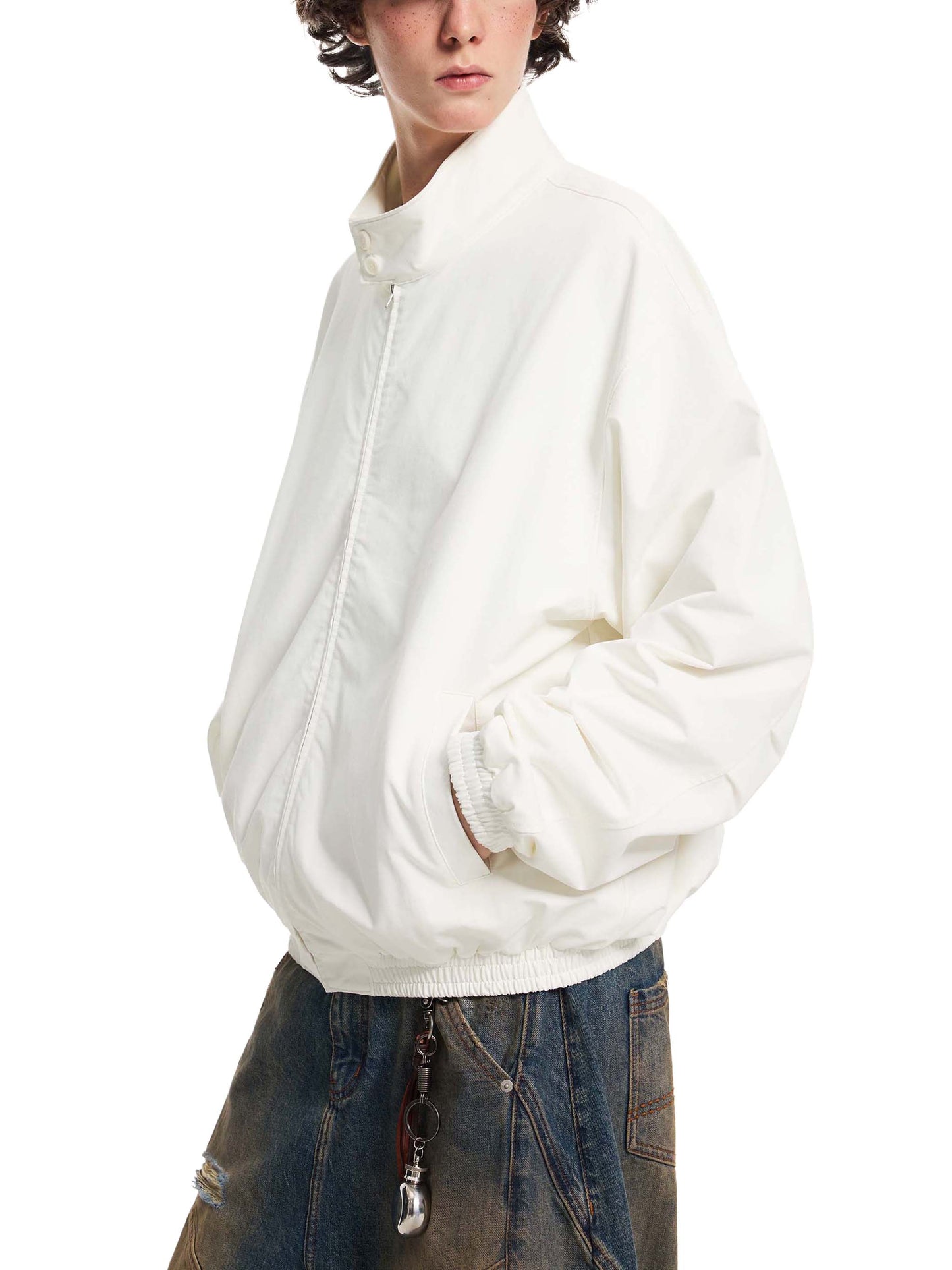 White stand-collar bomber jacket with front zipper and ribbed cuffs on a model, side view.
