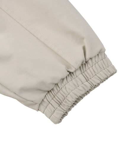 Beige bomber jacket sleeve cuff with elastic gathering and stitched seam