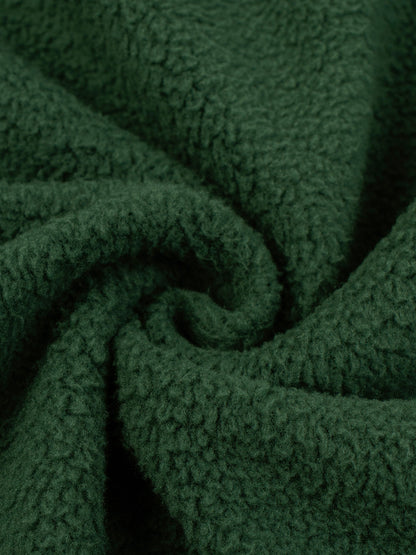 Green fleece fabric texture close-up with soft brushed pile