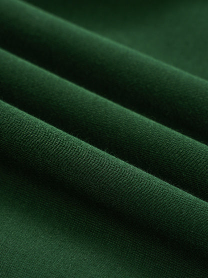 Green fleece fabric close-up with smooth knit surface