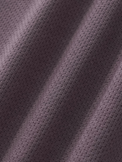 Cropped track jacket fabric close-up with knit texture and seam detail