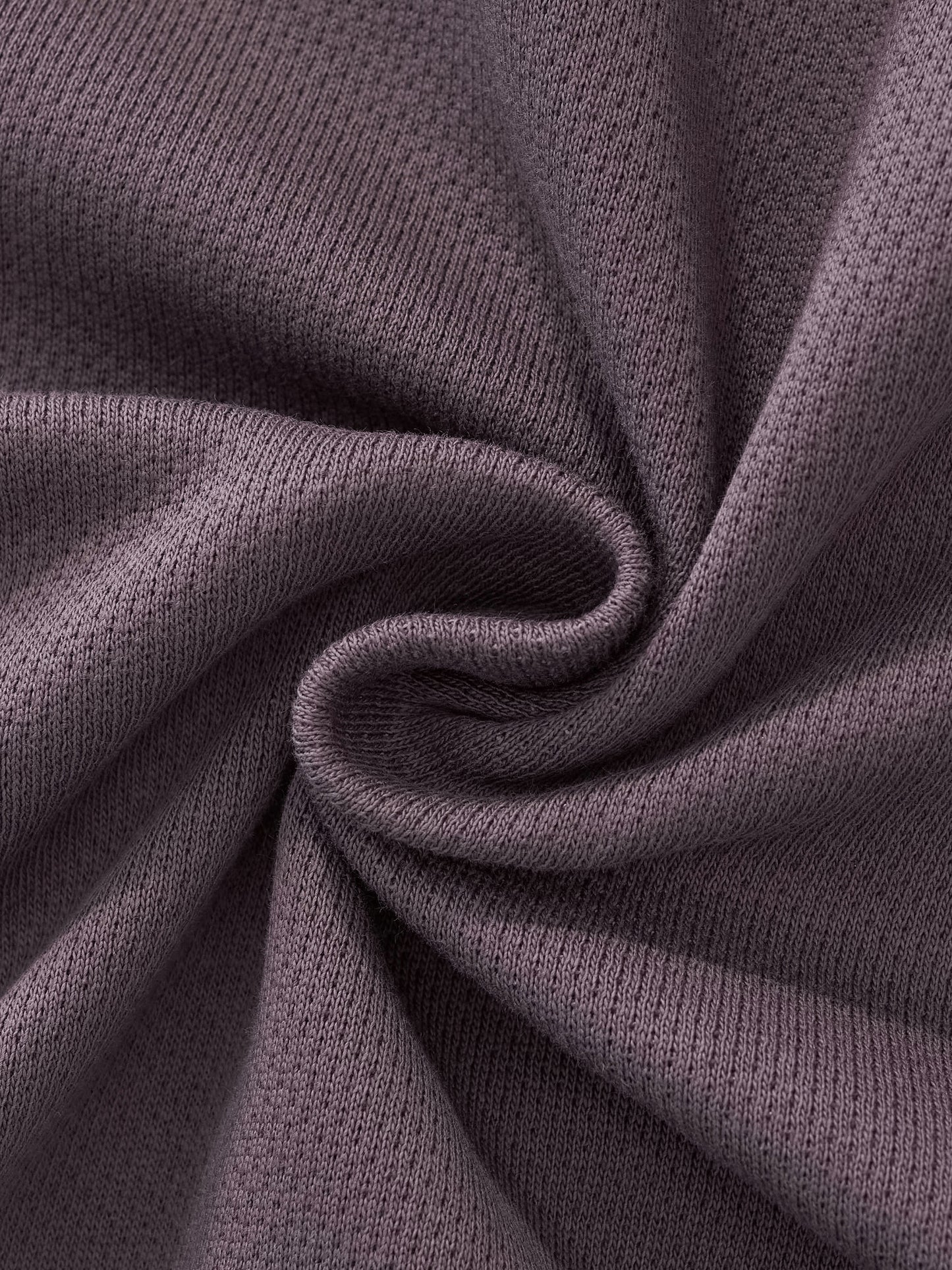 Cropped track jacket fabric close-up with ribbed trim and soft knit texture