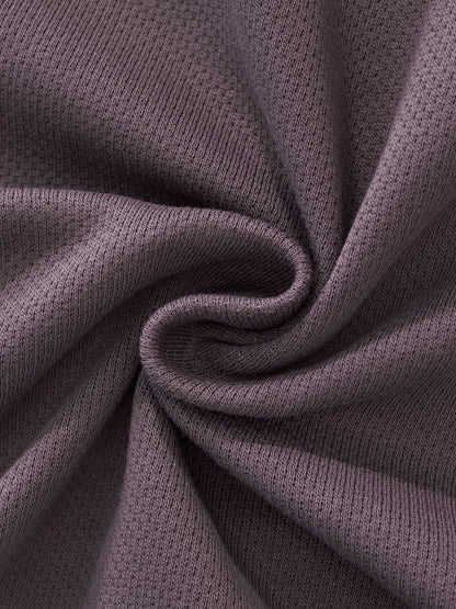Cropped track jacket fabric close-up with ribbed trim and soft knit texture