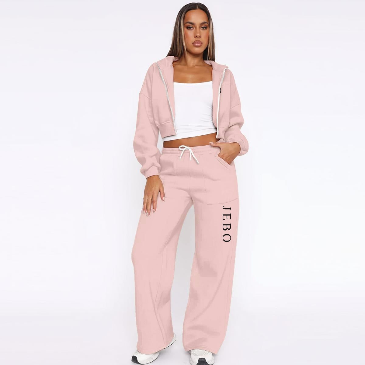 Women’s pink fleece tracksuit set with zip hoodie and drawstring wide-leg sweatpants.