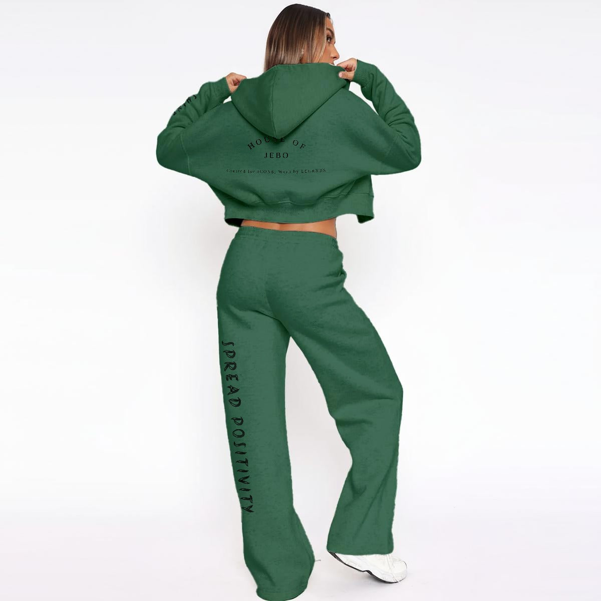 Women’s fleece tracksuit: deep green cropped hoodie and wide-leg pants with logo print.