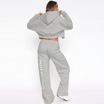 Gray fleece tracksuit: hooded zip hoodie and drawstring wide-leg joggers with vertical side text.